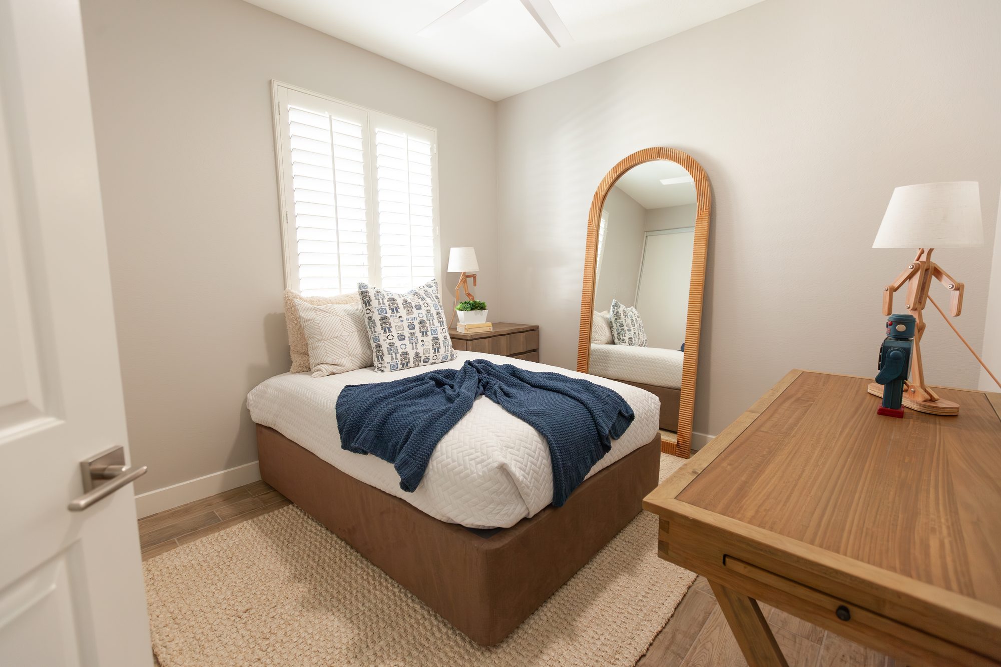 Guest bedroom with arched mirror